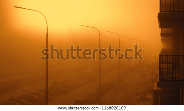 Fog in the city. Landscape with a street enveloped in\
thick fog