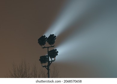 Fog In The City Moscow In Night. Light Of Street Spotlights. Light Beams Cut Through Moist Air. Natural Gray Background. Free Space.