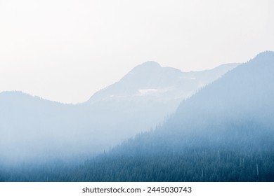 fog and clouds over mountain range in Canada