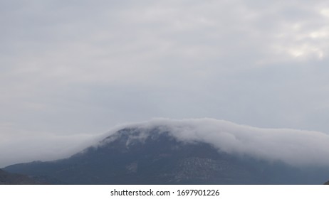 The fog is coming down from the mountain.