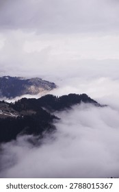 fog in the mountains. Clouds envelop the mountain peaks