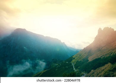 Fog in mountains. Fantasy and colorfull nature landscape. Nature conceptual image.