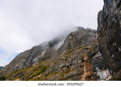 Fog in the mountains. Mountain in the clouds. Cloudy weather. Rock