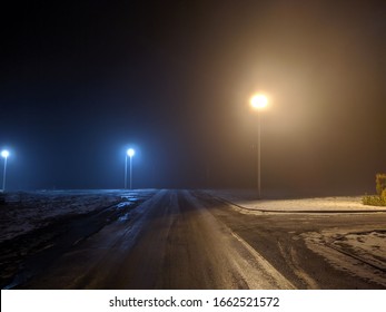 fog at night in a quiet and deserted city under the lighting of lampposts