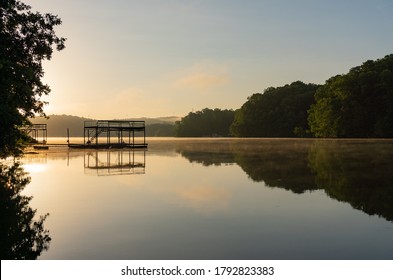 Fog On Lake Lanier In Georgia At Sunrise With The Silhouette Of A Dock; Landscape