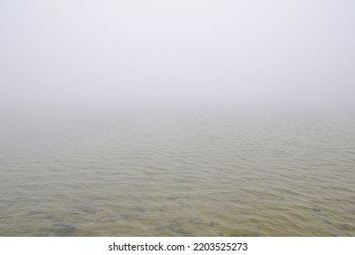 Fog on the water. Sea or lake in fog. Foggy weather. Calm beautiful relaxing misty landscape with water waves - Shutterstock ID 2203525273