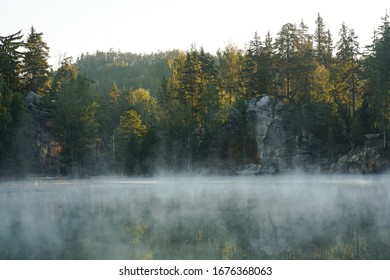 Fog over the water of a lake in Adršpach, Czech Republic. 