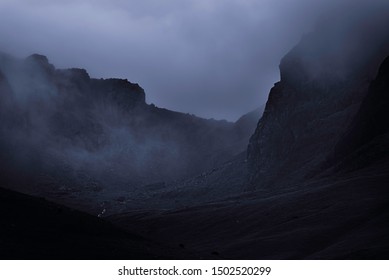 Fog in rocky mountain valley.Dark and dramatic landscape scene with atmospheric mood in English Lake District. - Powered by Shutterstock