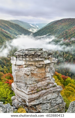 Fog rolls into the valley below Lindy Point on an autumn evening at Blackwater Falls State Park near Davis, West Virginia.