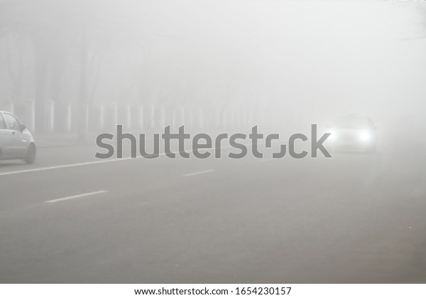 Fog weather and highway in city. Car\
Driving in Dense Fog. Dangerous Road\
Conditions