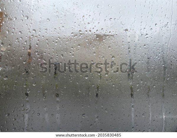 A fogged window in the car interior with small\
drops of water.