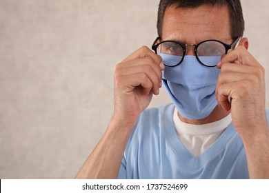 Fogging Glasses , Man, Medical Worker Wearing Medical Mask And Glasses Fogging. Coronavirus Prevention, Protection.