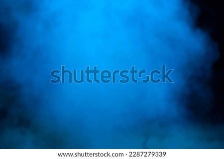 A foggy blue cloud of smoke at night