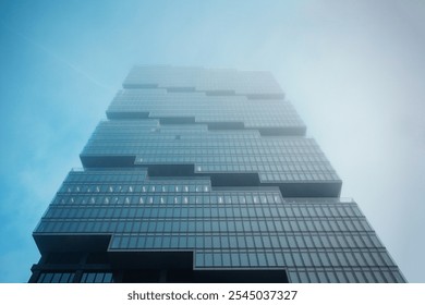 foggy construction site of a modern office skyscraper building in the sky - Powered by Shutterstock