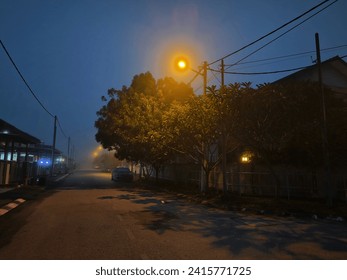 foggy dark night time scene at the residential street.