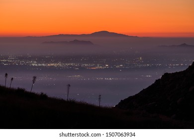 Foggy Dawn View Across The San Fernando Valley Towards Griffith Park And Santiago Peak In Los Angeles California.  