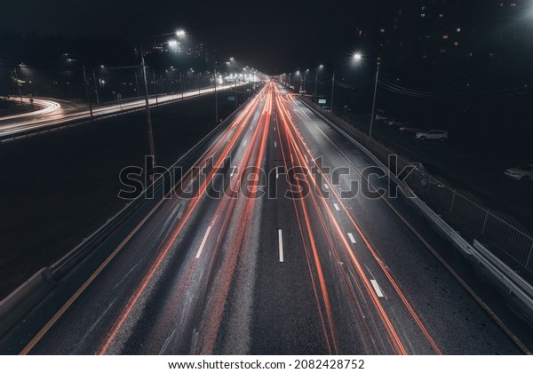Foggy misty night. Road illuminated by street\
lights, aerial view.