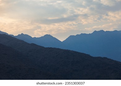 foggy morning in mountains - mountain range silhouettes in the desert at sunset sunrise is setting behind big mountain - Powered by Shutterstock