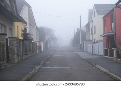 Foggy morning on an empty street in a typical Czech neighborhood with private houses. - Powered by Shutterstock