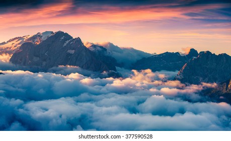 Foggy morning scene in the Val di Fassa valley. View from the bird's eye from Sella pass, Province of Bolzano - South Tyrol. Sunrise in Dolomite Alps, Italy, Europe. Dramatic summer landscape. - Shutterstock ID 377590528