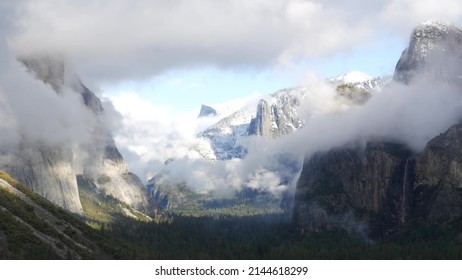 Foggy mountain, bare cliff or rocks, misty autumn weather, Yosemite valley, California USA. Scenic crags, bluff and fall forest. Brume or haze clouds dramatic timelapse. Tunnel view near Glasier point - Shutterstock ID 2144618299