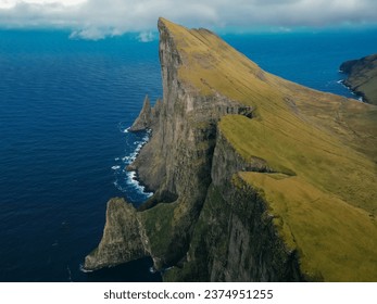 Foggy mountain peaks and clouds covering sea and mountains. Panoramical view from famous place - Sornfelli on Streymoy island, Faroe islands, Denmark. Landscape photography