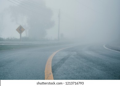 foggy rural asphalt highway perspective with white line, misty road, Road with traffic and heavy fog, bad weather driving