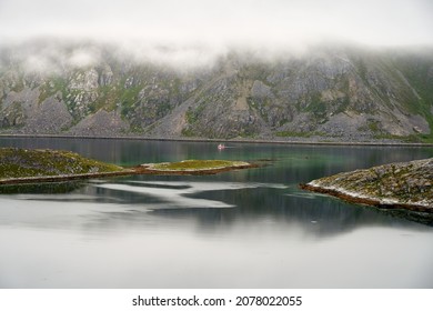 A foggy seascape from in northern Norway with a fishing boat, close to Nordkapp