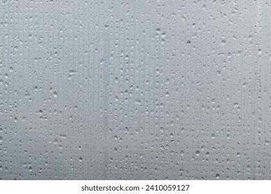 A foggy sheet of transparent plastic with a mesh structure. Water drops are arranged in lines. Close-up. Background. Texture. - Powered by Shutterstock