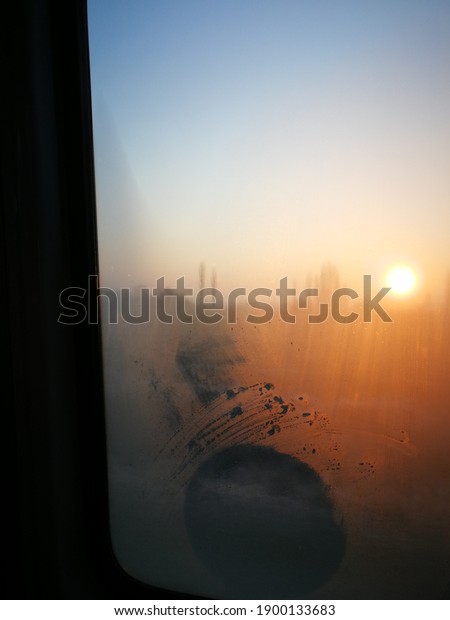 \
Foggy sunrise from the car window.\
Sunrise on a\
winter day