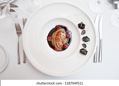 Foie gras dish on restaurant table shot from above - Powered by Shutterstock