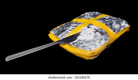 A Foil Wrapped Brick Of Cocaine With A Knife Cut In It