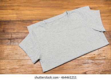 fold gray t-shirt on wooden background - Powered by Shutterstock