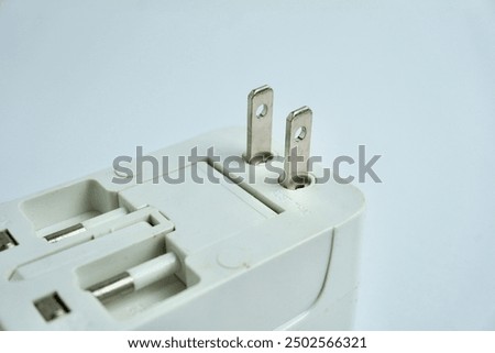 Foldable electrical plug with multiple plug types. Item to carry while traveling. Object photography isolated on white background.