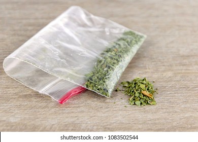 Folded Bag Of Synthetic Substance, Cannabis, Weed, Marijuana. On A Wooden Table, Top View