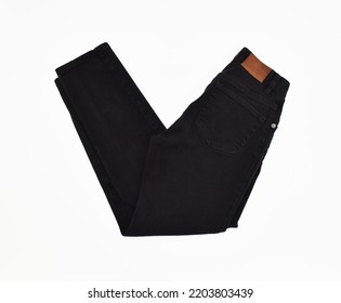 Folded black jeans side view on white background - Shutterstock ID 2203803439