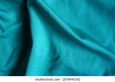 Folded blue green polyester fabric from above