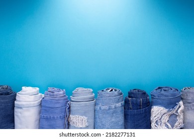 Folded blue jeans denim at paper background texture. Jeans fabric material - Shutterstock ID 2182277131