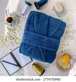 Folded Blue Terry Dressing Gown. Natural. Flatlay