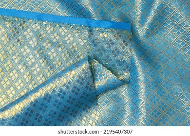 Folded Blue-colored Fabric Texture Background. This Brocade Fabric Is Made Of Polyester.