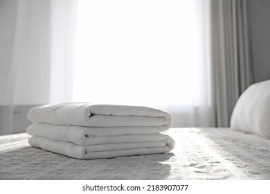 Folded Clean Blanket On Bed In Room
