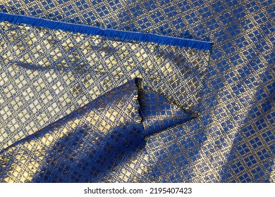 Folded Dark Blue Colored Fabric Texture Background. This Brocade Fabric Is Made Of Polyester.