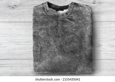 Folded Grey Sweatshirt On White Wooden Background