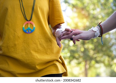 folded hands and hippie symbols - Shutterstock ID 2008342682