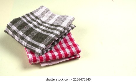 Folded Kitchen Textile Towels Of Different Colors, Household Cleaning Cloth. Closeup Of Cleaning Rag Isolated On A White Background.