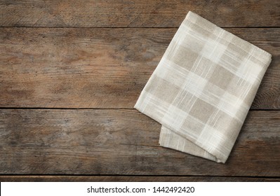 Folded Kitchen Towel On Wooden Table, Top View. Space For Text