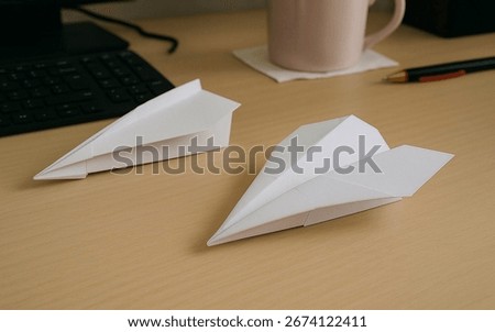 Folded paperplane on the work table