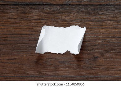 Folded Piece Of Note Pad Paper, Opened On Old Wooden Desk. Isolated On White.