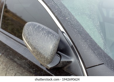 Folded Rear View Mirror Covered With A Layer Of Dry Mud To A Black Dirty Car With Turn Signals On The Outside Mirror Body Close-up Of The Vehicle Exterior.