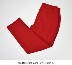 Folded red office pants side view on white background - Shutterstock ID 2204730445